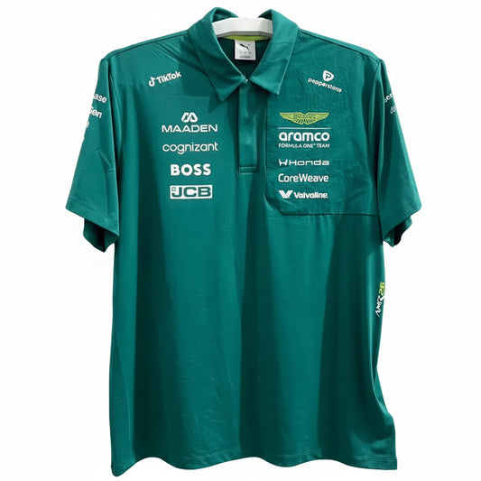 A teal green Mercedes-AMG F1 team polo shirt with various sponsor logos, displayed on a hanger against a white decorative screen.