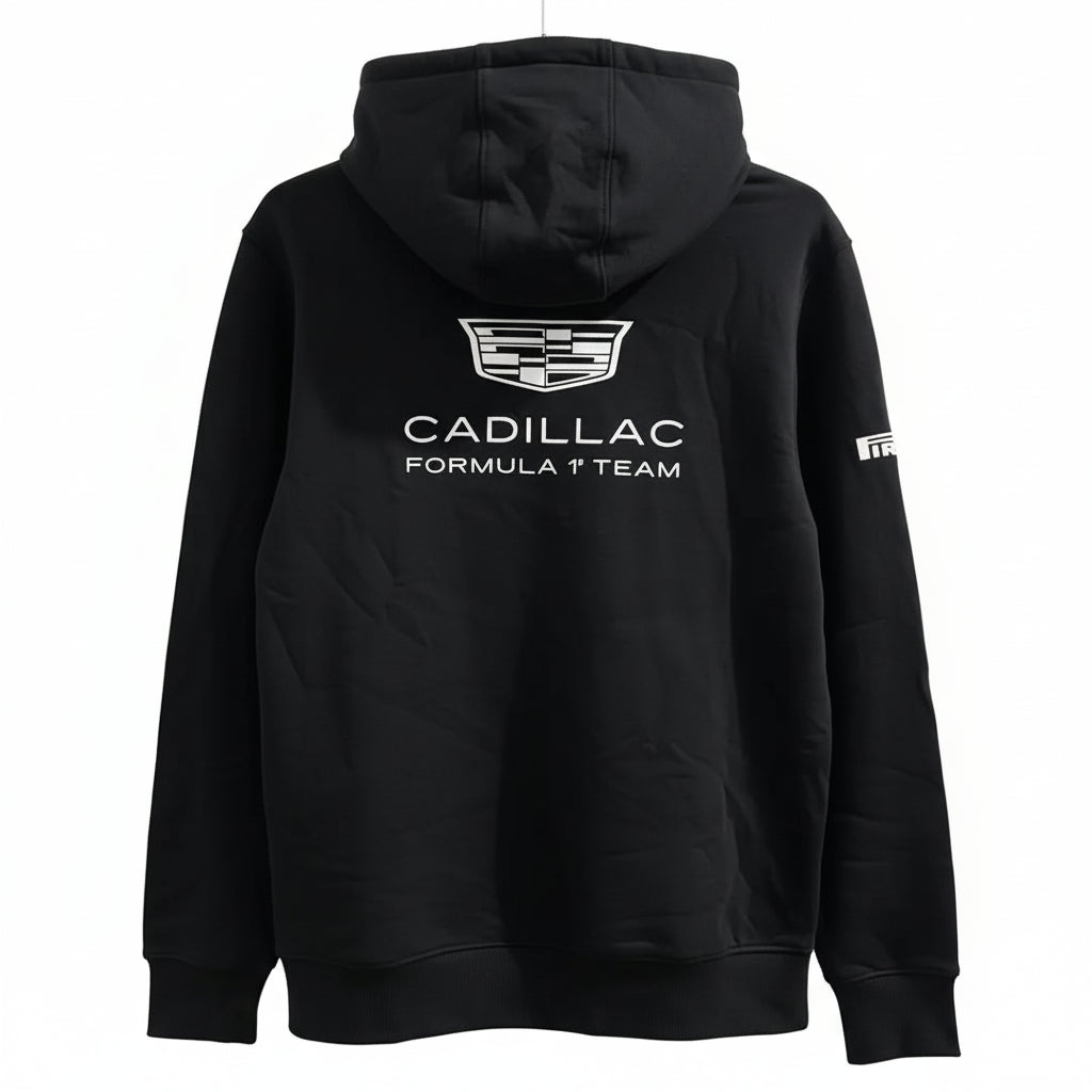 A black hoodie featuring a white printed Cadillac Formula 1 Team logo on the back, displayed against a decorative white leaf-patterned screen.