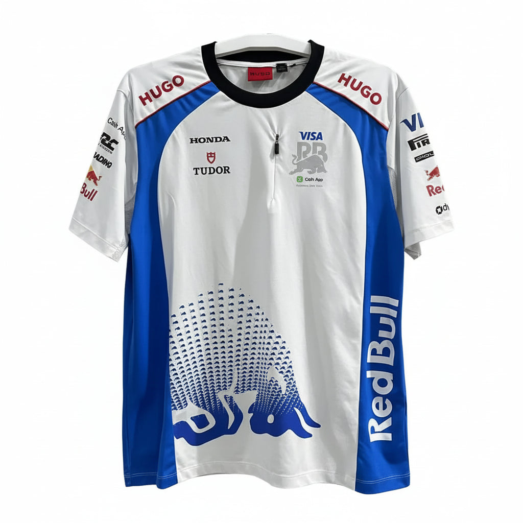 A white and blue Red Bull Racing team jersey with sponsor logos including Hugo, Honda, Tudor, Visa, and Cash App, hanging against a decorative black-and-white screen.