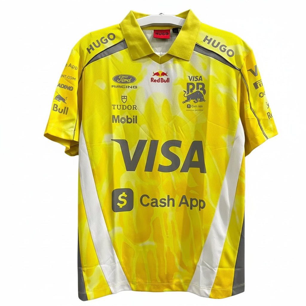 A yellow and white Ford Racing rugby jersey with sponsor logos including Visa, Mobil, Red Bull, and Tudor, hanging against a decorative white background.
