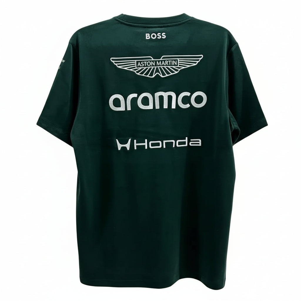 A dark green short-sleeve t-shirt with white printed sponsor logos, including BOSS, Aston Martin, Aramco, and Honda, displayed against a white decorative screen.