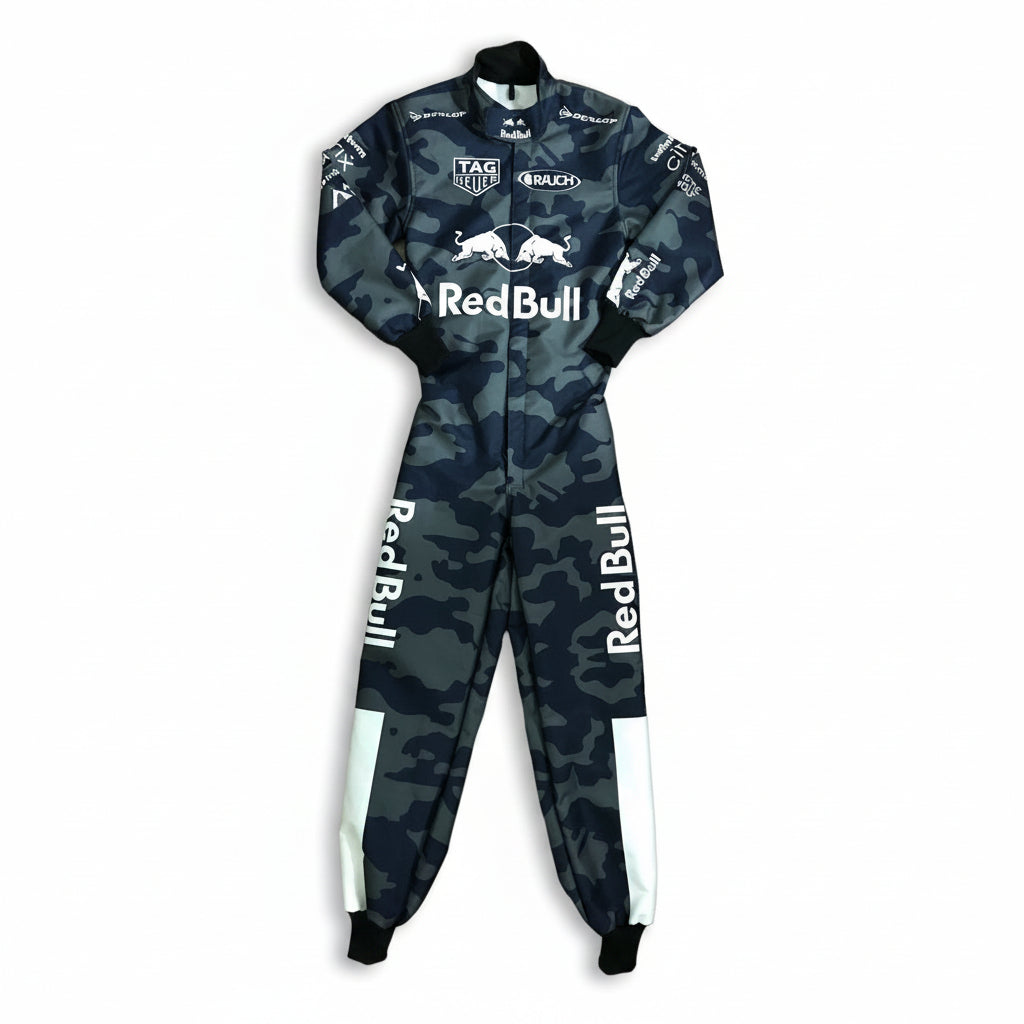 A full-body racing suit with a dark blue and gray camouflage pattern, featuring prominent white Red Bull logos on the chest and legs, and sponsor logos including TAG Heuer and Ruach on the sleeves and chest.