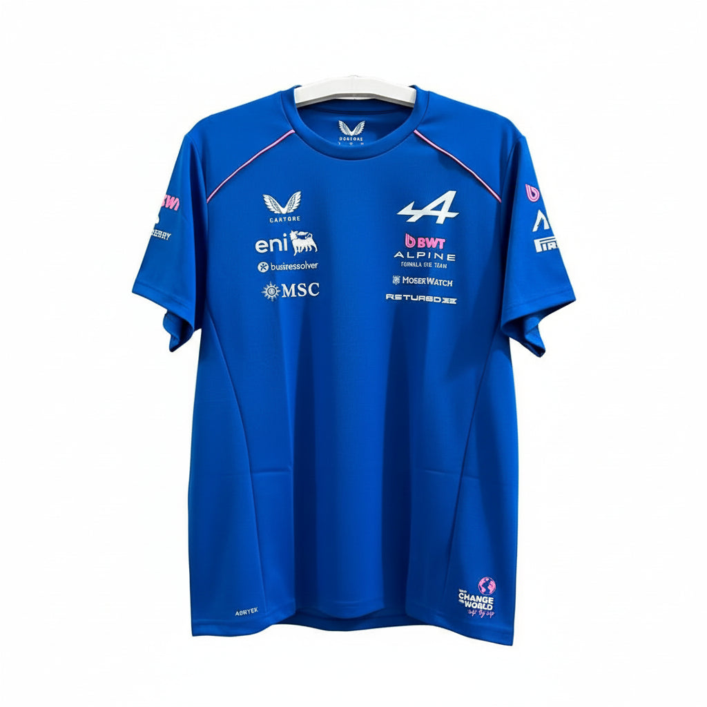 A royal blue short-sleeve athletic T-shirt hanging on a white hanger against a decorative white wall with leaf-shaped cutouts. The shirt features multiple sponsor logos including Castore, eni, bwr, MSC, and HANSBRUSH, as well as the number 4 and VALYDE branding.