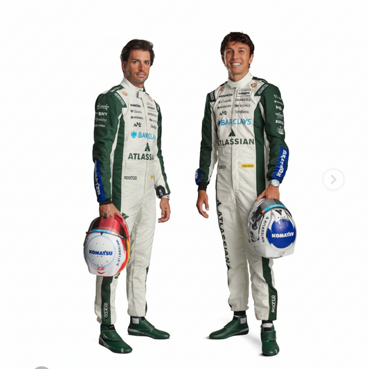 Two male race drivers standing against a plain light beige studio background, wearing matching white and dark green racing suits and holding helmets. Visible sponsor logos on the suits include Barclays, Atlas, Moss, and others, and the helmets show Komatsu branding.
